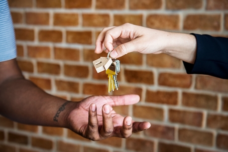 someone handing over the keys to someone else