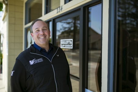 Eric Gullotta standing outside his office smiling
