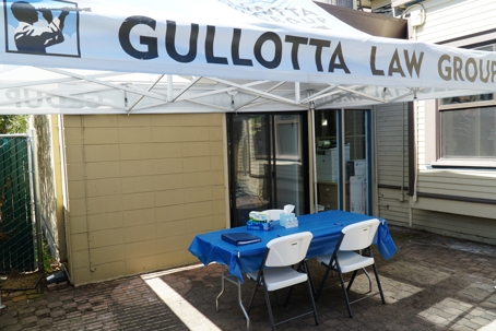 Gullotta Law Group tent outside building with table and chairs